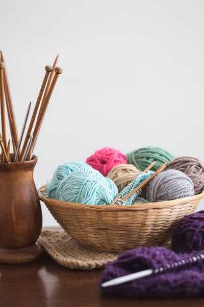basket of wool and knitting needles